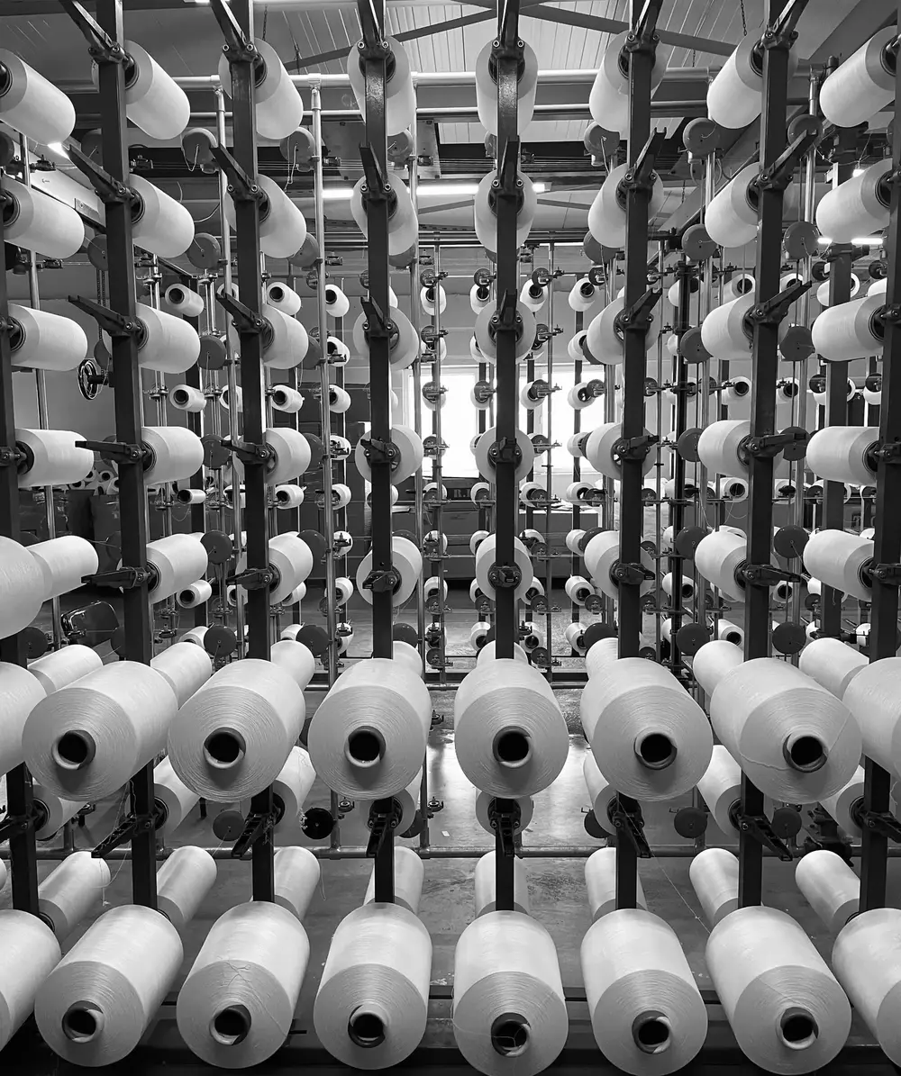Yarn cones lined up on the warping creel